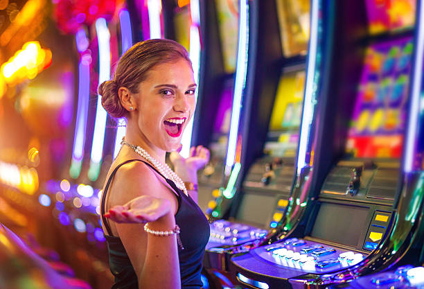 Young woman playing slot machines at the Casino